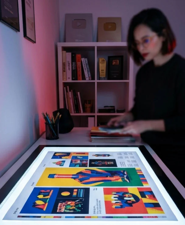 Printed design work in a softly lit creative studio